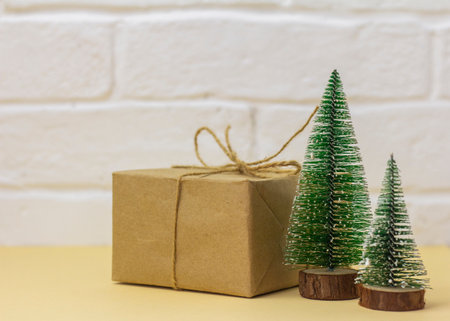 Craft paper gift boxes and small Christmas trees, copy space. Christmas conceptの写真素材