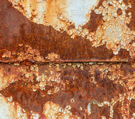 A rusty blue metal wall with fallen paint, a rusty background