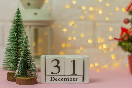 New Year. December, 31st. Calendar with a Christmas tree on a pink background with a bokeh. Winter timeの写真素材