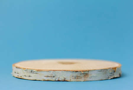 Podium made of natural wood for presentations and exhibitions on a blue background. Space for copyingの写真素材