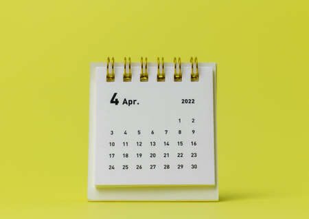 Desktop calendar for April 2022 on a yellow backgroundの写真素材