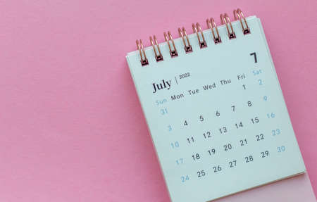 Desk calendar for July 2022 on pink background with copy spaceの写真素材