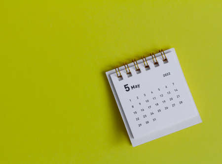 Desktop calendar for May 2022 on a yellow backgroundの写真素材