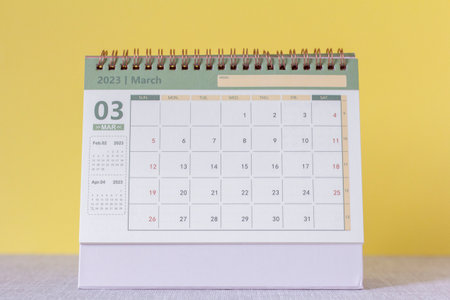 Desktop calendar for March 2023 on a yellow backgroundの写真素材