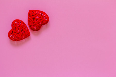 Pink background for Valentine's Day with a red heart shape. Space for copyingの写真素材