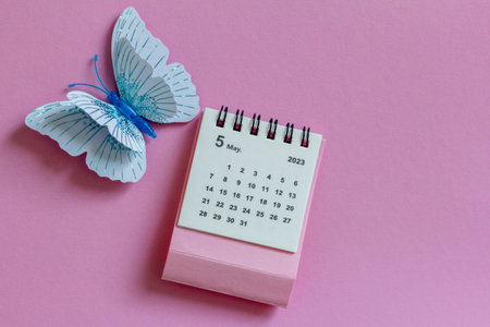 Calendar for May 2023 on a pink background with butterfliesの写真素材