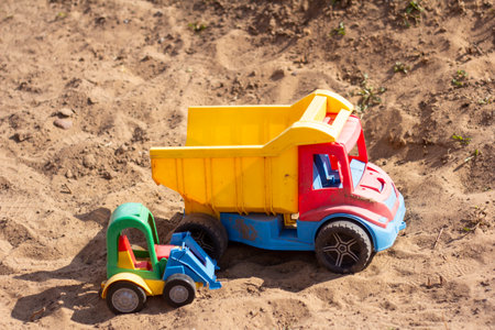 Children's toy cars in the sandbox.Forgotten toysの写真素材