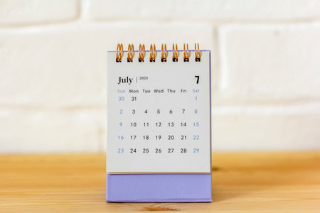 Desktop calendar for July 2023 on the table with a space to copyの写真素材