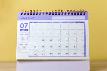 Desktop calendar for July 2023 on the table with a space to copyの写真素材