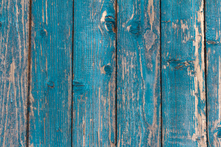 old wooden wall painted blue, weathered wooden background with nails and slitsの写真素材