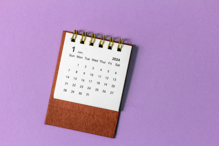 January 2024. Desk calendar for 2024 on a lilac background with copy spaceの写真素材