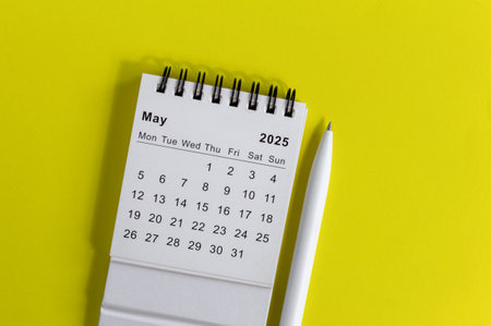Hello, May 2025 desk calendar for planning on yellow backgroundの写真素材
