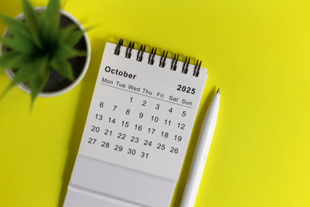 Desktop calendar for October 2025 on a yellow background