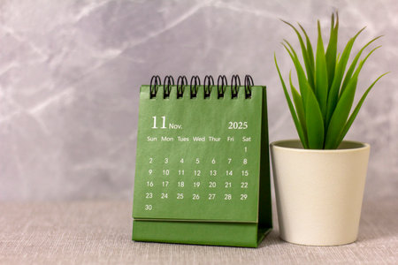 Hello, November 2025. A desktop calendar for planning on the table