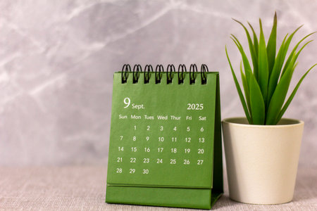 Hello, September 2025. Desktop calendar for planning on a gray background