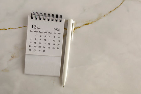 Hello, December 2025. Desktop calendar for planning on an abstract backgroundの写真素材