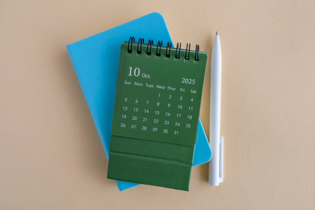 Hello, October 2025. Desktop calendar and notepad for writing on the desktop