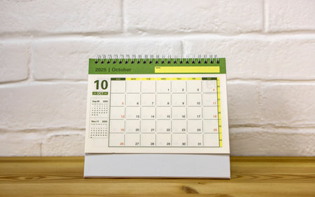 The desktop calendar for October 2025 is on the desk, where there is a place to copyの写真素材