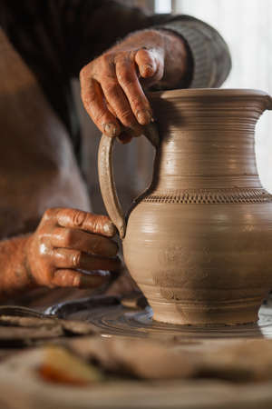 Potter working a piece of clay. Makes a jugの写真素材