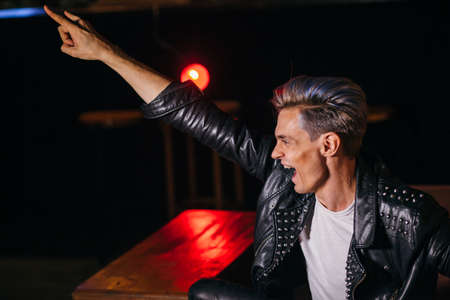 Young punker doing a rock hand gestureの写真素材