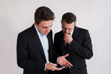 Young businessmen with the smartphone on a white backgroundの写真素材