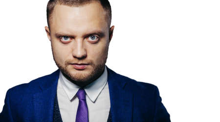 Portrait of serious fashionable handsome man in blue suit looking at camera. white backgroundの写真素材