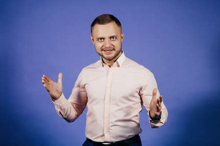 Happy businessman clapping in a pink shirtの写真素材