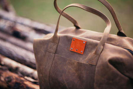 Travel backpack on the wooden bench in the forest. Summer active hiking and trekking tools.の写真素材