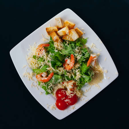 Caesar salad with shrimp on a plateの写真素材