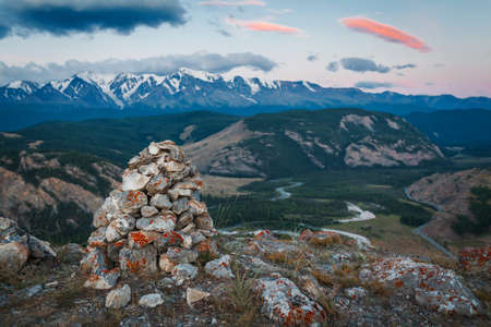 Rock cairn marking a hiking route in the Altai with a view to mountain peaks.の写真素材