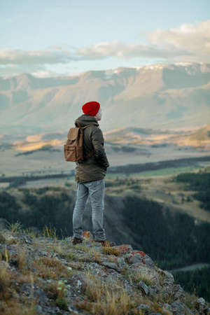 hiker at the top of a rock with backpack enjoy sunny day.の写真素材