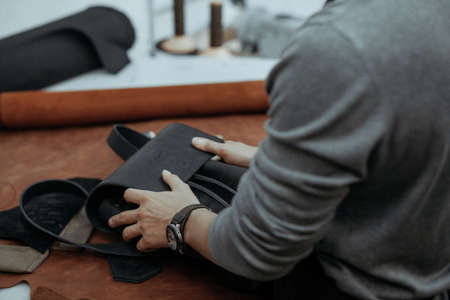 The master makes a leather bag. A close up, a product from skin in hands. Handworkの写真素材