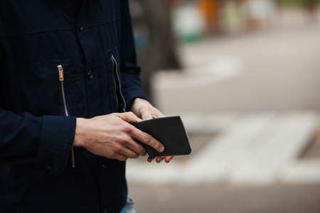 Hipster man hands holding wallet with credit cards and stack of money.