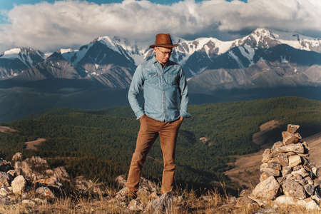 The person in a hat standing on mountain topの写真素材