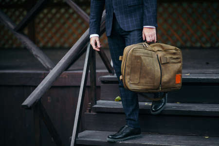 Businessman standing and holding a briefcase in hand working with confidenceの写真素材
