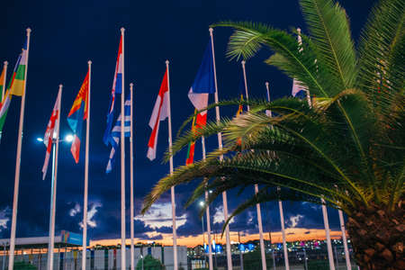 Many National Flags Blowing in the Wind on a Blue Sky Background extreme closeup.の写真素材