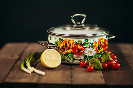 Iron pan with products on wooden backgroundの写真素材