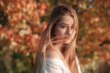 Portrait of bright-haired girl with hair covered faceの写真素材