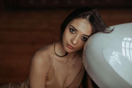 Portrait of beautiful woman leaned head on tub
