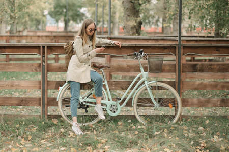 Girl looking in her phone sitting on bike