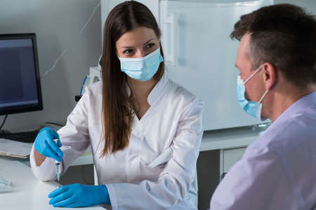 Doctor vaccinating patient in clinic. Medicine. Covidの写真素材