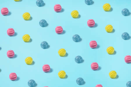 Colorful Wolen Balls on a bright blue background. Summer colors inspired art photography. Cotton...