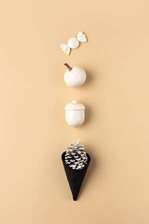 Ice cream made with black ice-cream cone, acorn, pumpkin and pine cone. Autumn sweet dessert. Flat...