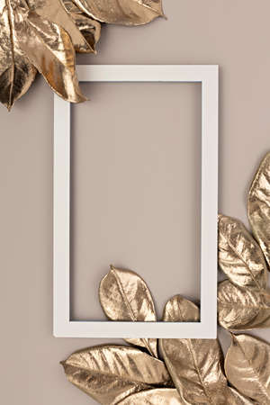 Top view of gold Fall leaves on pastel background. Flat lay. Minimal Autumn concept. Creative copy space.の写真素材