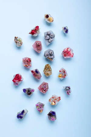 Creative layout made with fruit ice cubes, organic berries and dried flowers. Minimal summer concept. Flat lay.の写真素材