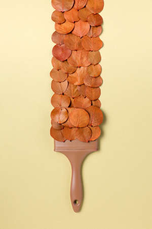 Creative Top view flat lay autumn concept composition. Paint brush dried bright autumn background...