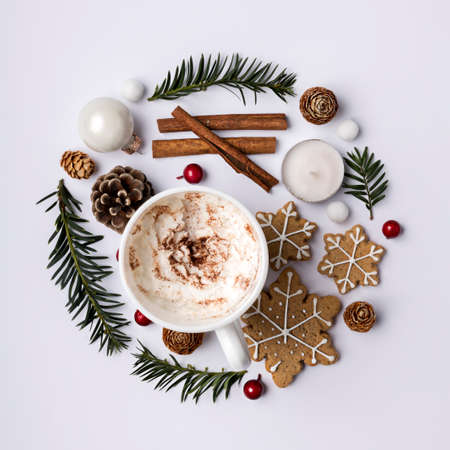Christmas holiday decorative layout made with fir branches, holly berries, vanilla sticks and...