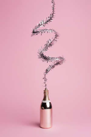 Celebration champagne explosion on pastel pink background. Minimal party concept. New Year and Christmas celebration idea.の写真素材