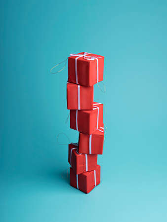 Christmas holiday decorative layout made with present ribbon wrapped gift box on blue background. Minimal winter or New Year concept with copy space. Seasonal greeting card.の写真素材