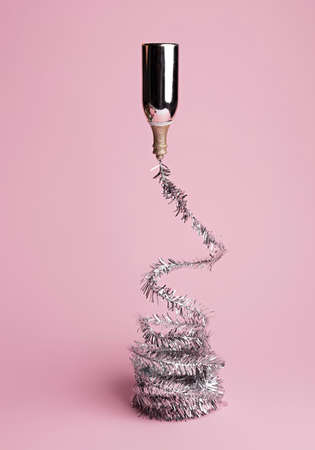 Celebration champagne explosion on pastel pink background. Minimal party concept. New Year and...